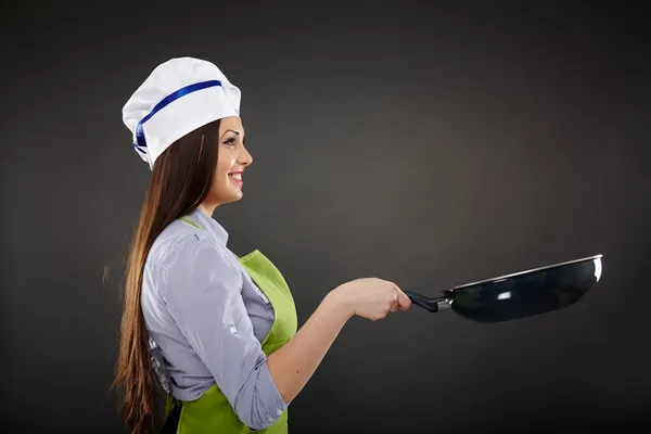 Woman chef holding a wok pan — Stock Photo, Image