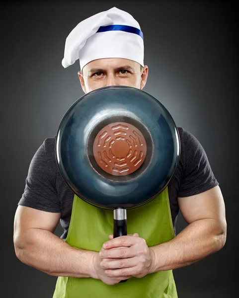 Chef homme cachant son visage derrière un wok pan — Photo