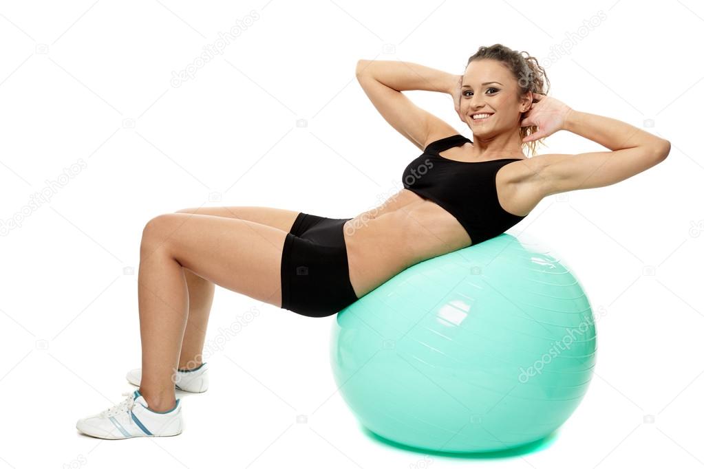 Woman doing abs on gym ball