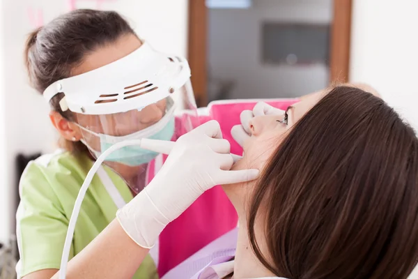 Mulher dentista trabalhando com o perfurador — Fotografia de Stock