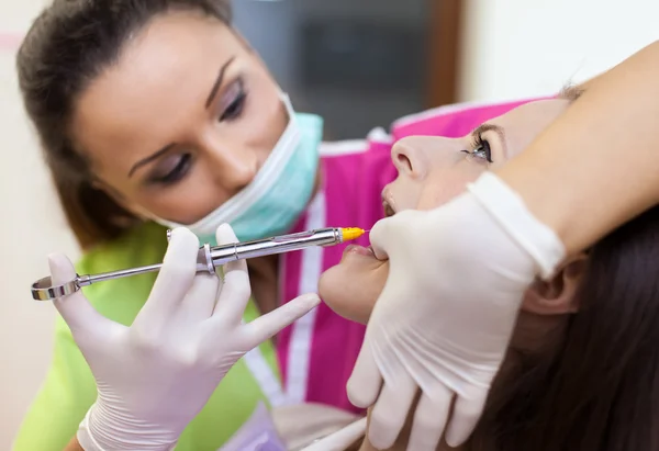 Mulher dentista dando a seu paciente uma injeção de anestesia — Fotografia de Stock