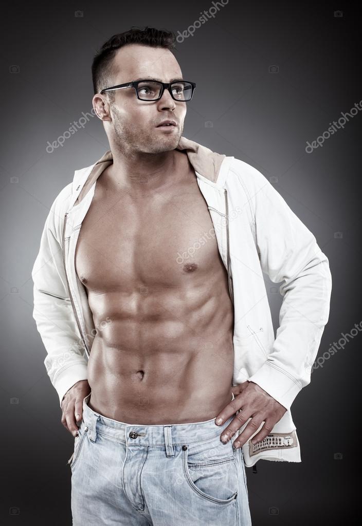 Fashionable sexy man wearing an unbuttoned shirt and eyeglasses