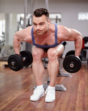 Man working with dumbbells clipart