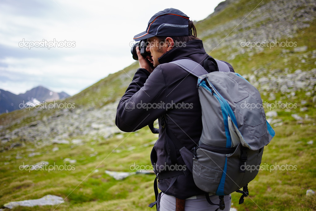 Hiker taking photos of landscape