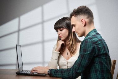 Young business people working from home on a laptop