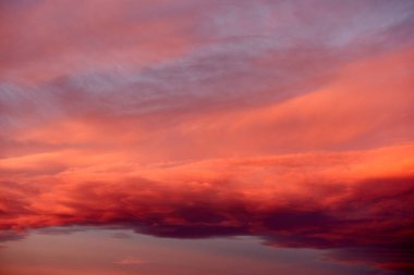 Vibrant cloudscape with orange clouds at sunset, useful as a backdrop