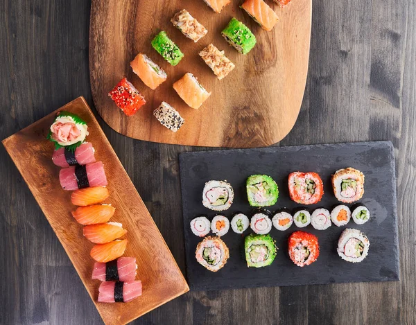 Flat lay shot of a variety of sushi on a wooden board