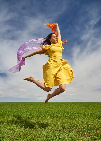 Action Shot Young Attractive Woman Yellow Dress Jumping Joy Green — Stock Photo, Image