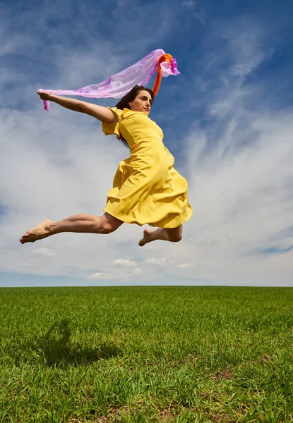 Action Shot Young Attractive Woman Yellow Dress Jumping Joy Green —  Fotos de Stock