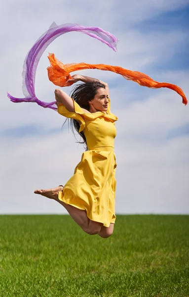 Action Shot Young Attractive Woman Yellow Dress Jumping Joy Green — Stock Photo, Image