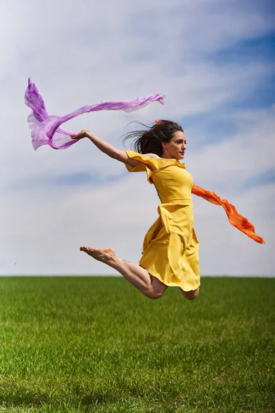 Action Shot Young Attractive Woman Yellow Dress Jumping Joy Green — Foto Stock