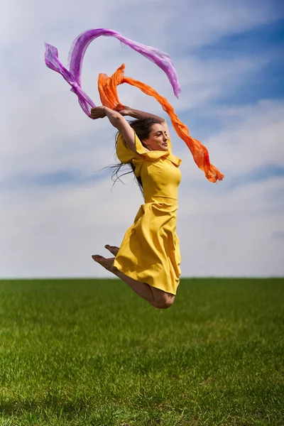 Action Shot Young Attractive Woman Yellow Dress Jumping Joy Green — Stockfoto