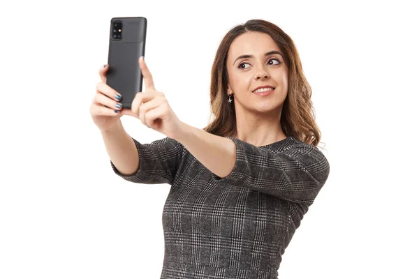 幸せな若い実業家は彼女のスマートフォンで自撮り 白い背景に隔離されました — ストック写真