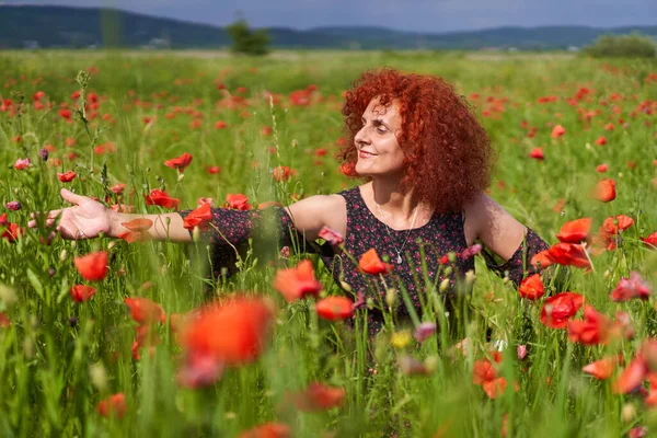 可愛い髪赤毛女性で花のドレスでケシのフィールド — ストック写真