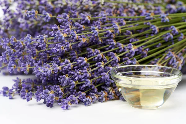 Lavender products and fresh bouquet in closeup on white background