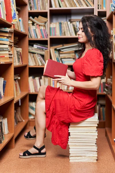 Beautiful Woman Red Dress Library Sitting Stack Books Reading — Stock Fotó