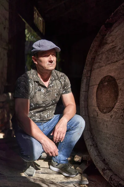 Middle aged man in a ruined house and barn, natural light portrait