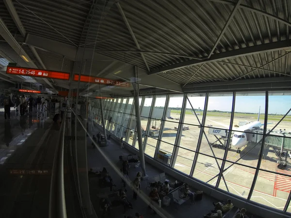 Parked aircraft in the airport through the gate window. — Stock Photo, Image