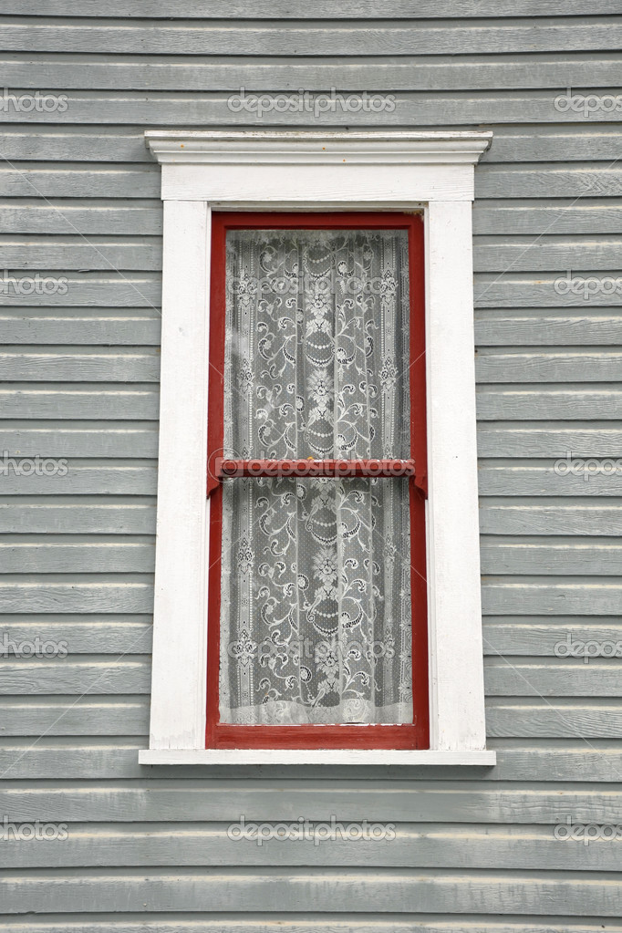 Old window with lace curtains