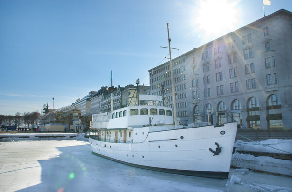 White ship in spring sun rays