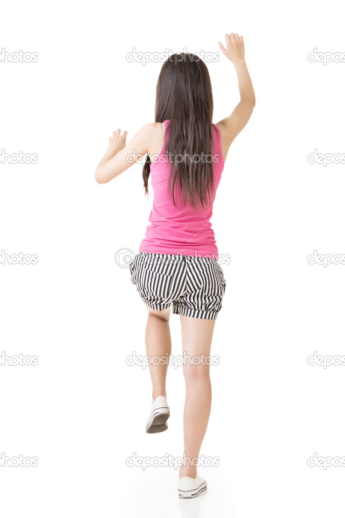 Young asian woman climbing up the wall.