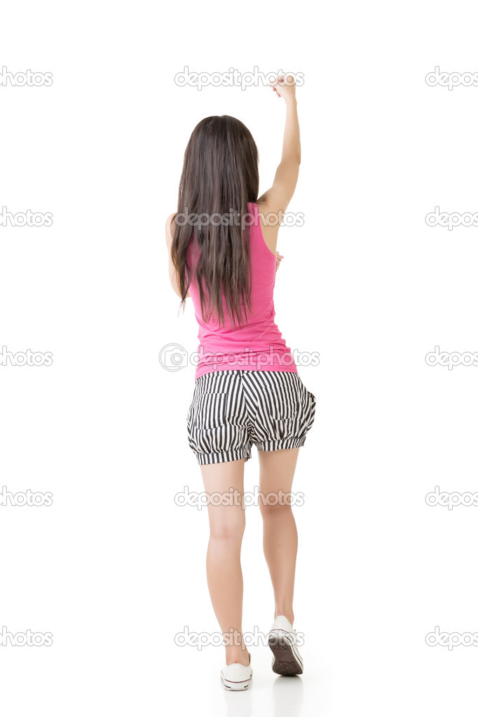 Young asian woman pulls an imaginary rope.
