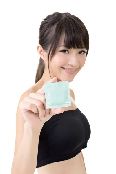 Young pretty asian woman with a condom — Stock Photo, Image