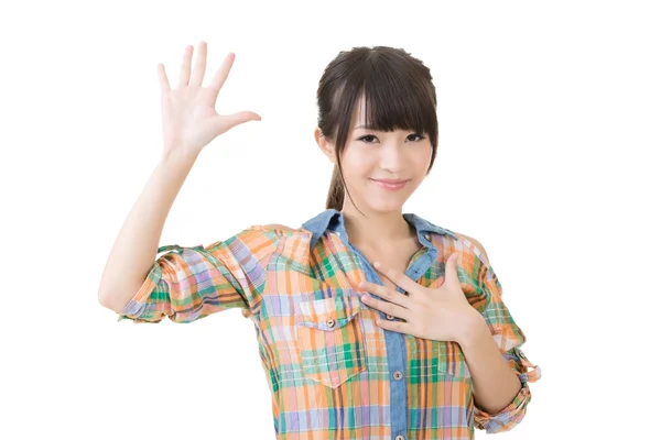 Asian young woman give a gesture of swear. — Stock Photo, Image