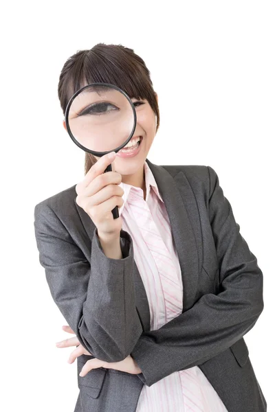 Young asian woman looking through a magnifying glass — Stock Photo, Image