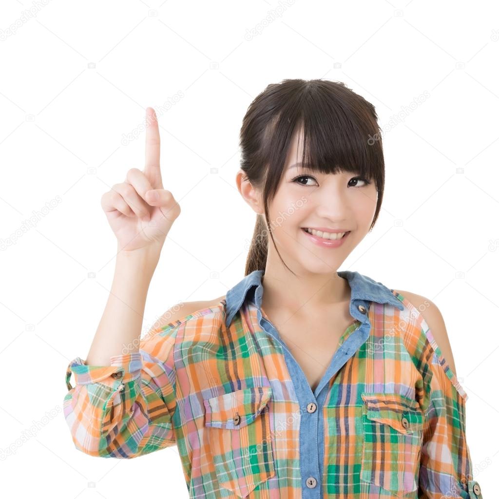 Young asian woman pointing up
