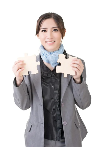 Asian business woman with two pieces of puzzle — Stock Photo, Image