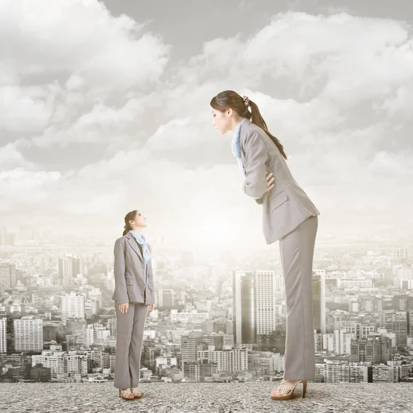 Businesswoman looking on her big version on the roof. — Stock Photo, Image