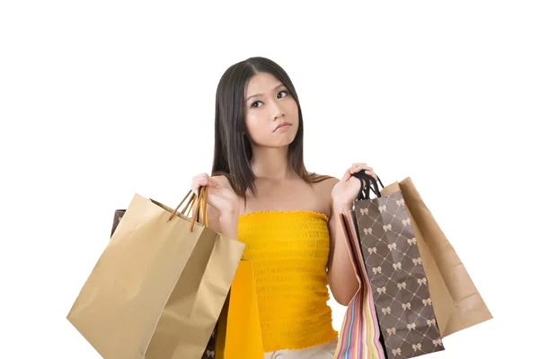 Upset asian woman holding shopping bags — Stock Photo, Image