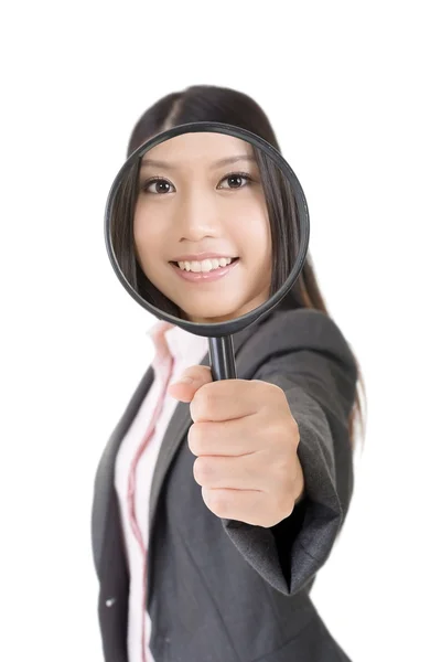 Smiling asian businesswoman holding magnifying glass — Stock Photo, Image