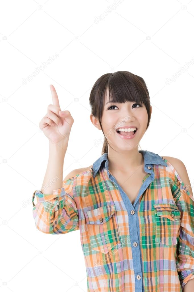 Young pretty asian woman pointing up