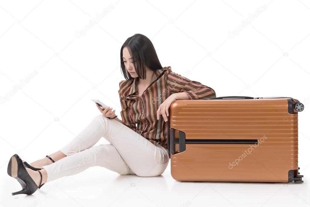 Asian woman sit on ground with a luggage