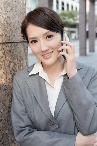 Aziatische zakenvrouw praten over slimme telefoon — Stockfoto