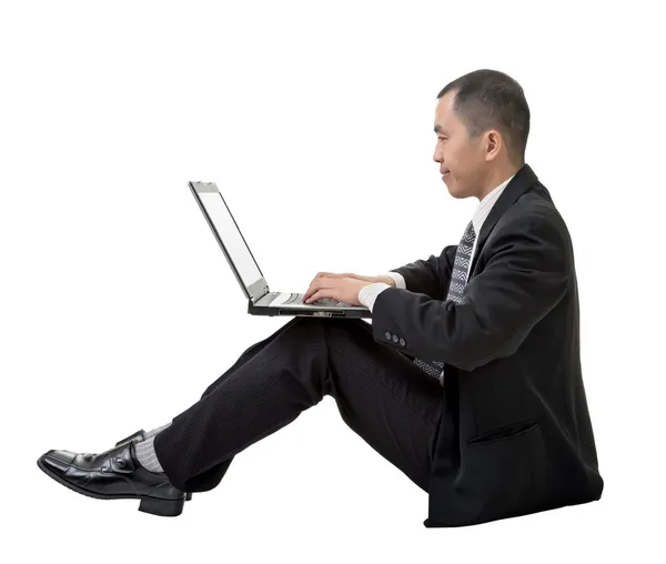 Uomo d'affari che utilizza laptop a terra — Foto Stock