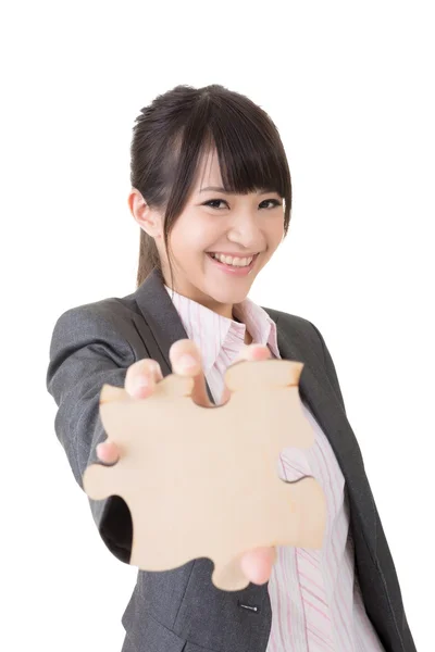 Asian business woman holding a piece of puzzle — Stock Photo, Image