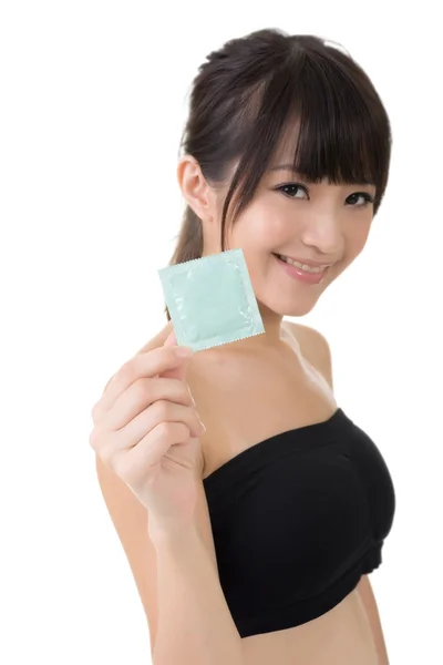 Young pretty asian woman with a condom — Stock Photo, Image
