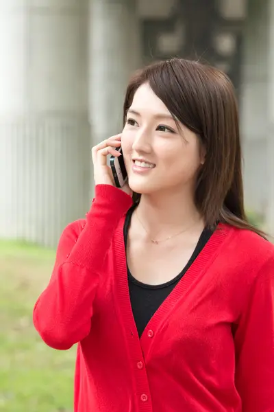 Smiling Asian young woman take a call Royalty Free Stock Photos