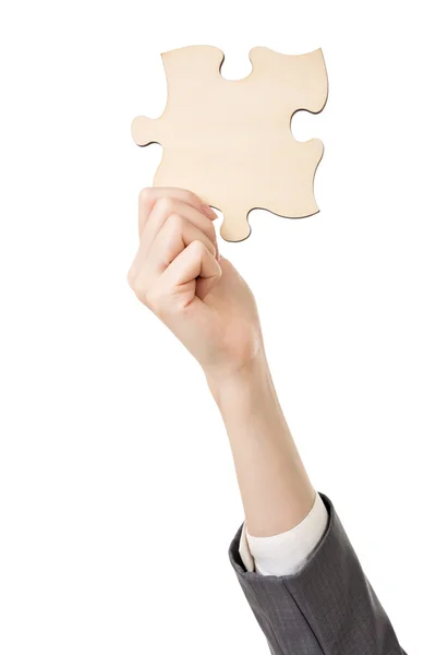 Business woman's hand holding a jigsaw puzzle — Stock Photo, Image