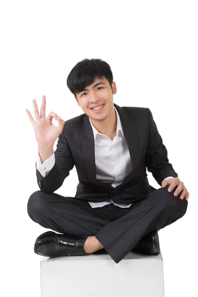 Asian businessman sit and give you an okay sign — Stock Photo, Image