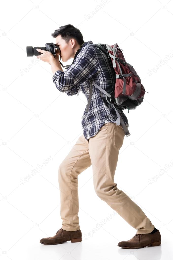 Asian young male backpacker take a picture