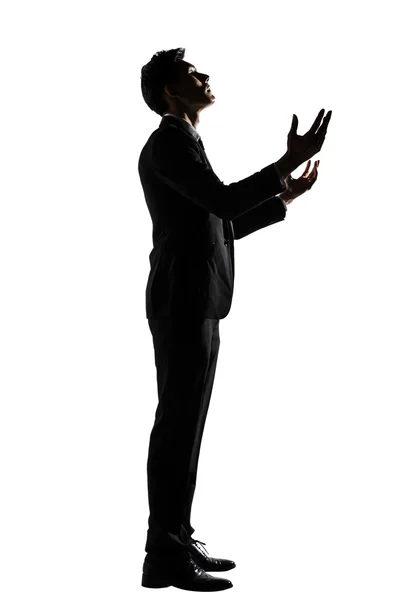 祈っているアジア系のビジネスマンのシルエット — ストック写真