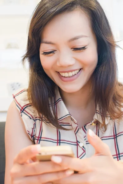 Asian woman holding her cellphone — Stock Photo, Image