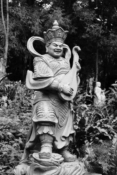 Aged asian god statue — Stock Photo, Image