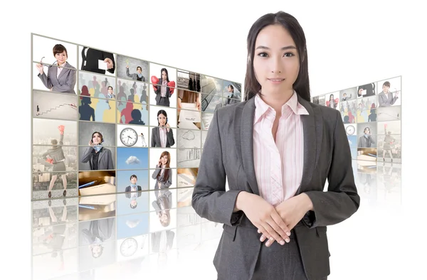 Woman standing in front of TV — Stock Photo, Image