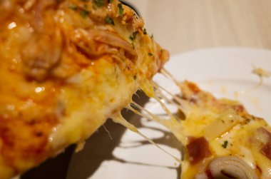 Bir restoranda küçük bir dilim pizza yemek.