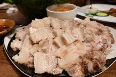 boiled pork belly with garlic sauce in a plate